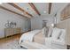 Bright primary bedroom featuring exposed beams, and a dresser at 15517 Possum Track Rd, Raleigh, NC 27614