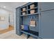 Mudroom with bench seating, wood floors, and blue built in cabinets at 15517 Possum Track Rd, Raleigh, NC 27614