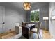 Bright office space with a large window and a modern light fixture with desk and accent rug at 15517 Possum Track Rd, Raleigh, NC 27614