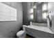 Modern powder room features marble countertop, sleek fixtures, and decorative wall art at 15517 Possum Track Rd, Raleigh, NC 27614