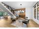 Chic sitting area featuring a modern chandelier, hardwood floors, and access to a staircase at 15517 Possum Track Rd, Raleigh, NC 27614