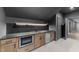 Basement bar featuring granite countertops, undermount sink, and stainless steel microwave at 15517 Possum Track Rd, Raleigh, NC 27614