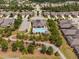 Aerial view of the community clubhouse, swimming pool, and surrounding homes at 1604 Vineyard Mist Dr, Cary, NC 27519