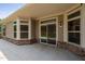 Back patio featuring brick facade, large windows and sliding glass doors at 1604 Vineyard Mist Dr, Cary, NC 27519