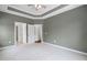 Spacious bedroom with neutral carpet, crown molding, and open doorways to attached rooms at 1604 Vineyard Mist Dr, Cary, NC 27519
