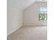 Bright bedroom featuring a large window and neutral carpeting at 1604 Vineyard Mist Dr, Cary, NC 27519