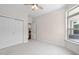 Neutral bedroom with double closets, ceiling fan, and a large window at 1604 Vineyard Mist Dr, Cary, NC 27519