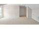 Spacious bonus room features neutral carpeting and a door to storage at 1604 Vineyard Mist Dr, Cary, NC 27519