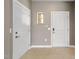 Bright foyer featuring tile flooring, a side window, and access to a side entry door at 1604 Vineyard Mist Dr, Cary, NC 27519