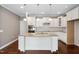 Bright kitchen features granite countertops, stainless steel appliances, and custom white cabinetry at 1604 Vineyard Mist Dr, Cary, NC 27519