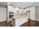 Bright kitchen features granite countertops, stainless steel appliances, and custom white cabinetry at 1604 Vineyard Mist Dr, Cary, NC 27519