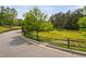 Scenic landscape with green field, small trees, and wooden fence at 1604 Vineyard Mist Dr, Cary, NC 27519