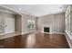 Open living room with hardwood floors, a fireplace, and ample natural light from large windows at 1604 Vineyard Mist Dr, Cary, NC 27519