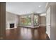 Spacious living room with a fireplace, large windows, and rich hardwood flooring at 1604 Vineyard Mist Dr, Cary, NC 27519