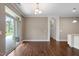 Bright living room featuring hardwood floors, and sliding glass doors to the outdoor patio at 1604 Vineyard Mist Dr, Cary, NC 27519