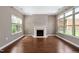 Bright and open living room with hardwood floors, a fireplace, and plenty of natural light at 1604 Vineyard Mist Dr, Cary, NC 27519