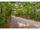 Paved path with wooden fence borders and lush trees at 1604 Vineyard Mist Dr, Cary, NC 27519