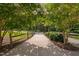 A serene path with wooden fence offers a peaceful walking trail amidst lush greenery at 1604 Vineyard Mist Dr, Cary, NC 27519