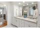 Bright bathroom featuring double sinks, marble countertops and a built-in storage cabinet at 1700 St Marys St, Raleigh, NC 27608