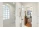 Bright bathroom showcasing glass block window and a glimpse into an adjacent bedroom at 1700 St Marys St, Raleigh, NC 27608