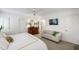Primary bedroom with hardwood floors, large window and a sitting area at 1700 St Marys St, Raleigh, NC 27608