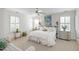 Bright primary bedroom featuring hardwood floors, white walls, and two large windows at 1700 St Marys St, Raleigh, NC 27608