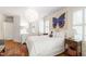 Charming bedroom with hardwood floors, a unique light fixture and a whimsical wall art at 1700 St Marys St, Raleigh, NC 27608