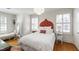 Bright bedroom with unique headboard and wicker furniture, creating a relaxing and airy space at 1700 St Marys St, Raleigh, NC 27608