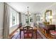 Elegant dining room featuring hardwood floors, a chandelier, and ample natural light at 1700 St Marys St, Raleigh, NC 27608