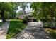 Charming two-story home with a brick chimney, white picket fence, and well-manicured lawn at 1700 St Marys St, Raleigh, NC 27608