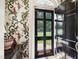 Foyer with unique wallpaper design and a view through the front door to the exterior at 1700 St Marys St, Raleigh, NC 27608