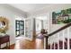 Entryway with hardwood floors, staircase, and access to the dining room with natural light at 1700 St Marys St, Raleigh, NC 27608
