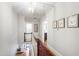 Upstairs hallway featuring hardwood floors, staircase, and access to multiple rooms at 1700 St Marys St, Raleigh, NC 27608