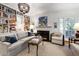 Living room featuring a fireplace, built-in bookcases and French doors at 1700 St Marys St, Raleigh, NC 27608