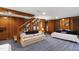 Cozy wood-paneled living room featuring staircase, plush seating, and bright blue carpet at 1700 St Marys St, Raleigh, NC 27608