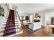 Spacious living room with hardwood floors, fireplace, and a staircase at 1700 St Marys St, Raleigh, NC 27608