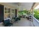 Inviting porch with wicker furniture, ceiling fans, and a view of lush greenery at 1700 St Marys St, Raleigh, NC 27608