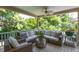 Relaxing covered porch with cushioned wicker seating, ceiling fans, and scenic views at 1700 St Marys St, Raleigh, NC 27608