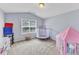 Bedroom featuring a window, neutral walls, carpet, and toys at 1808 Pennypacker Ln, Durham, NC 27703