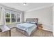 Cozy bedroom featuring a comfortable bed with built in drawers and lots of natural light at 1808 Pennypacker Ln, Durham, NC 27703