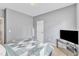 Bedroom featuring neutral walls, a bed, a television on a stand, and great natural light at 1808 Pennypacker Ln, Durham, NC 27703