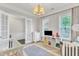Bedroom featuring a chandelier, white furniture and neutral tones, creating a peaceful environment at 1808 Pennypacker Ln, Durham, NC 27703
