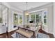 Bright dining area with a table and bench is illuminated by natural light from a bay window at 1808 Pennypacker Ln, Durham, NC 27703