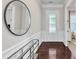 Elegant entryway featuring hardwood floors, a stylish mirror, and a glass-paneled front door at 1808 Pennypacker Ln, Durham, NC 27703