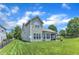 Well-maintained backyard with a screened porch and patio, blending seamlessly into the landscaped lawn at 1808 Pennypacker Ln, Durham, NC 27703