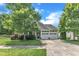 Inviting home exterior with two-car garage, lush trees, and a well-manicured lawn at 1808 Pennypacker Ln, Durham, NC 27703