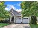 Charming home with a two-car garage framed by lush greenery and a well-manicured lawn at 1808 Pennypacker Ln, Durham, NC 27703