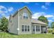 View of a two-story home featuring an outdoor patio area, screened in porch, and a large backyard at 1808 Pennypacker Ln, Durham, NC 27703