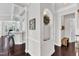 Hallway with dark hardwood floors, leading to an open kitchen and living spaces with natural light at 1808 Pennypacker Ln, Durham, NC 27703