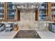 Modern kitchen boasts an electric stove, tile backsplash, and wooden cabinets with glass doors at 1808 Pennypacker Ln, Durham, NC 27703